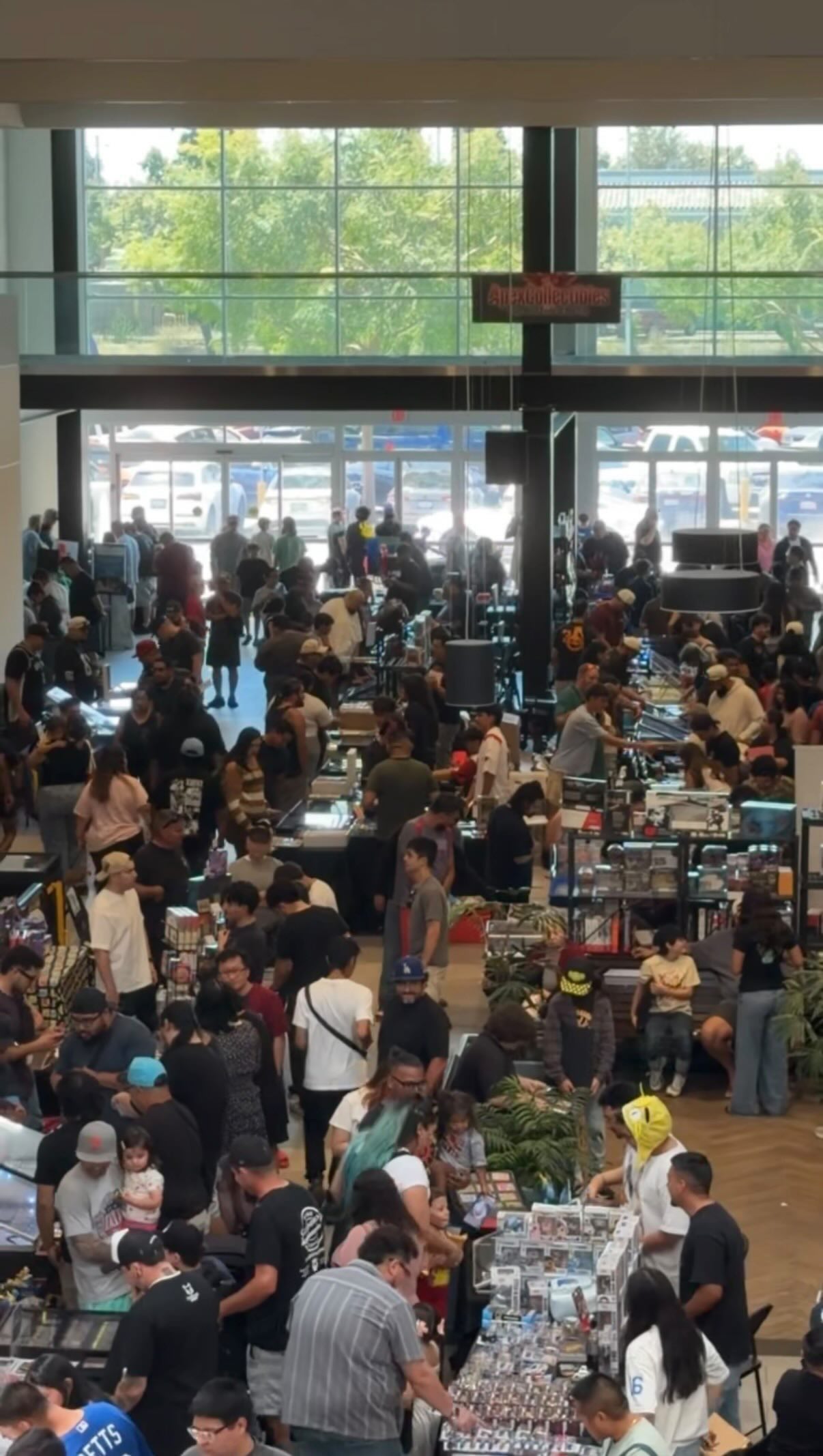 Families and collectors shopping at indoor collectibles event