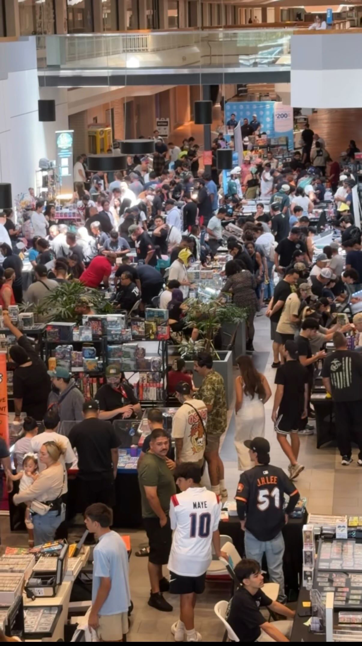 Crowded collector show floor with vendors and attendees