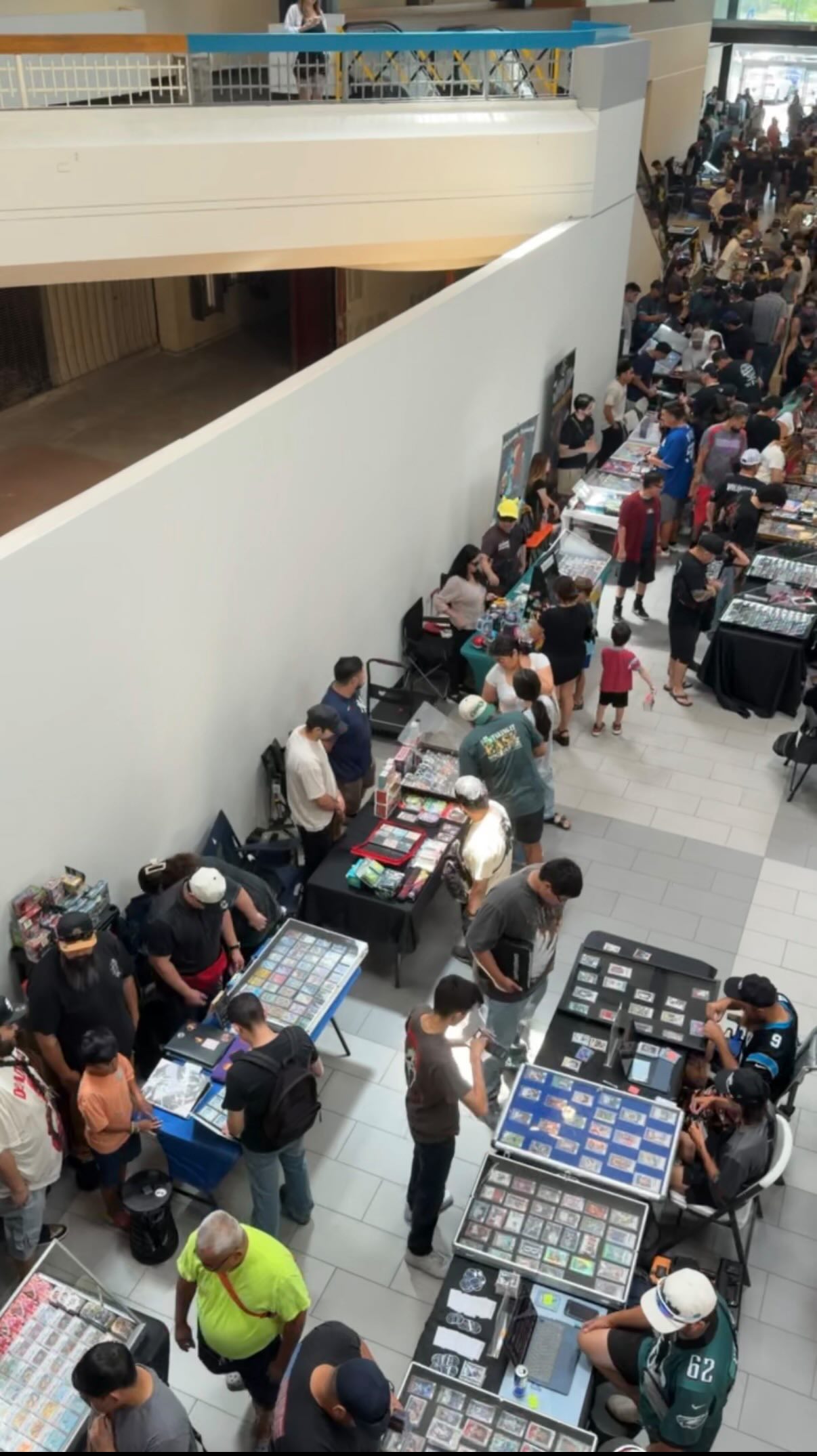 Shoppers browsing display cases at collector show