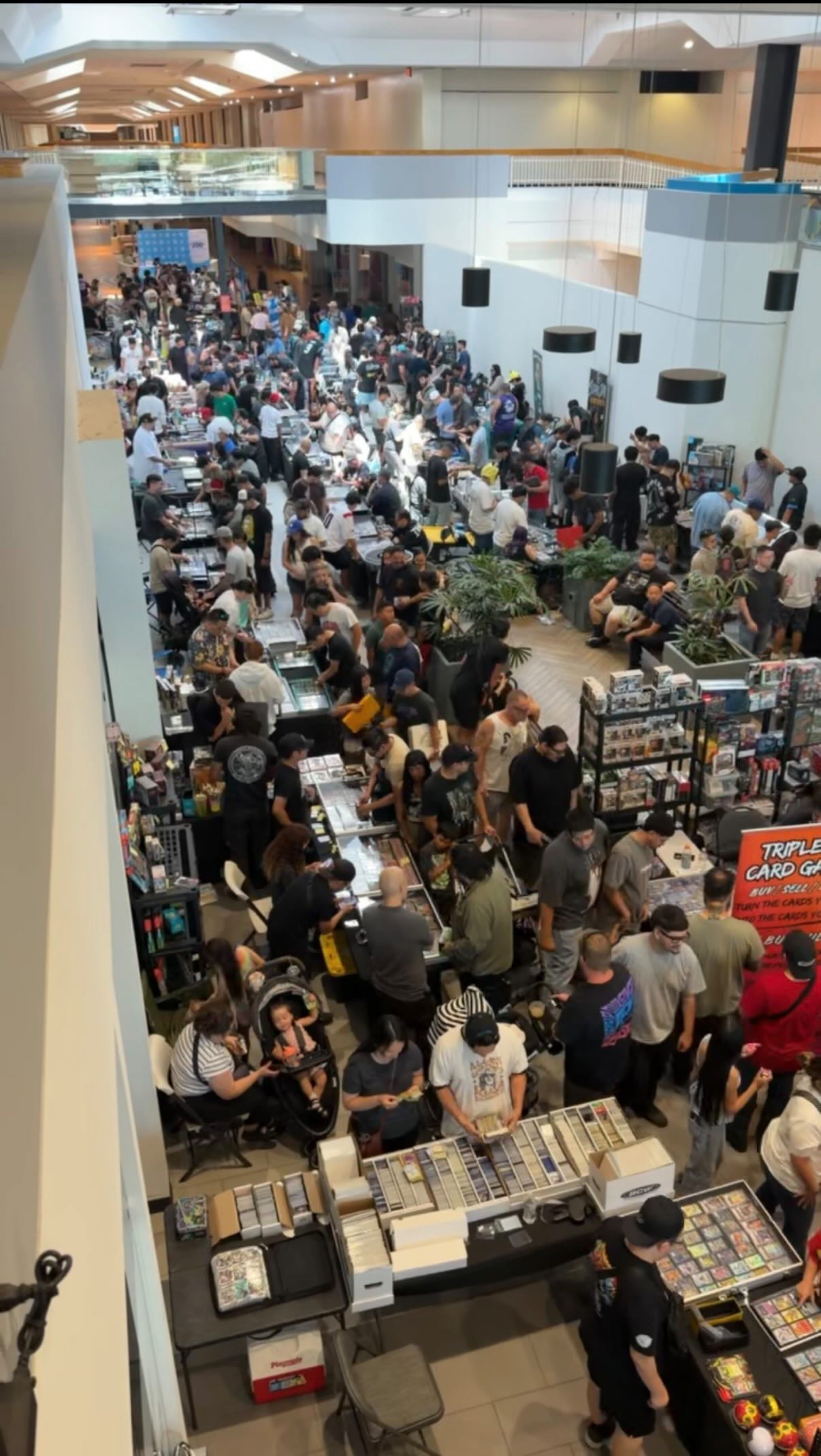 Busy sports card vendor tables at collector show